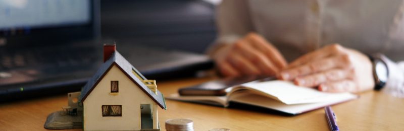 A closeup shot of a person thinking of buying or selling a house